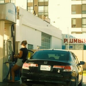 woman-refueling-black-car-at-gas-station-j8dgydkzq90