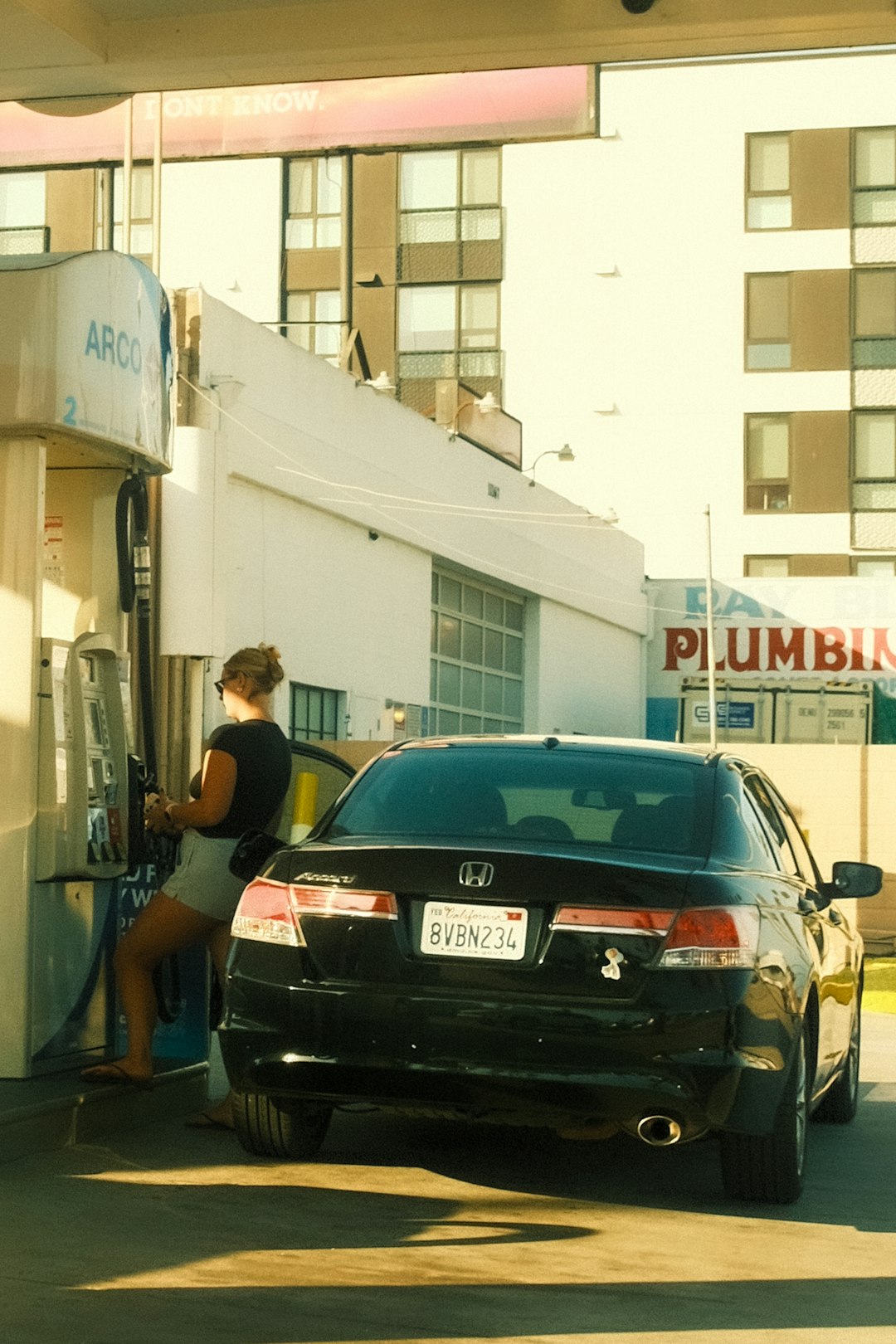 woman-refueling-black-car-at-gas-station-j8dgydkzq90